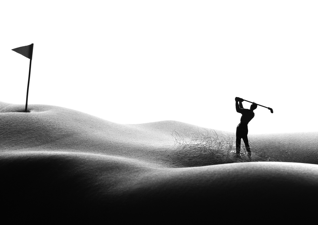   Bodyscapes  black and white photograph of golfer taking a swing on the nude female body.