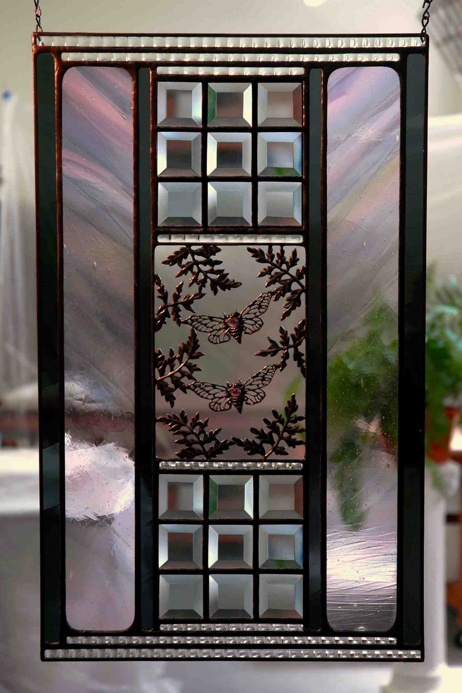 glass & metal artwork depicting cicadas & leaves